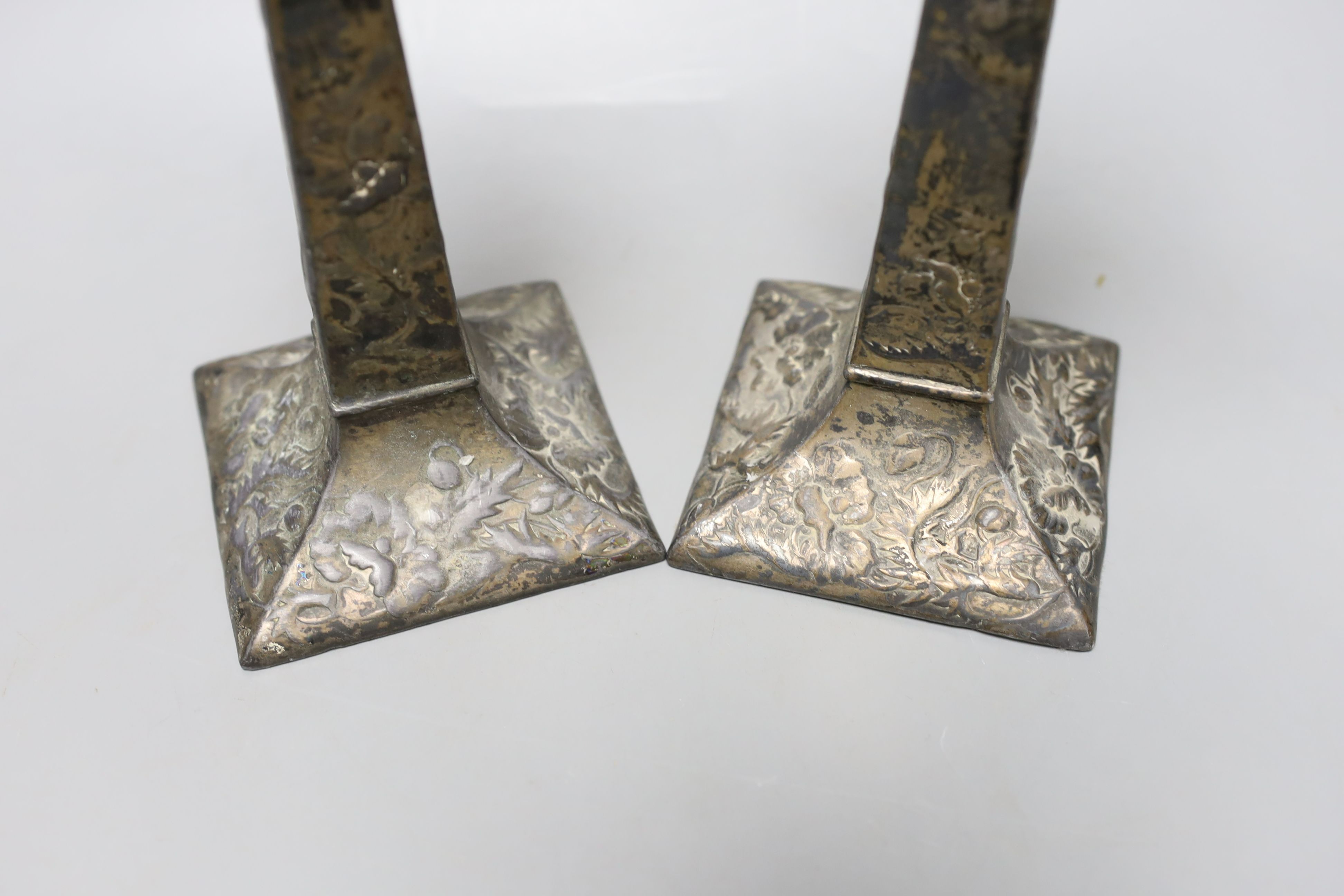 A pair of Japanese square footed embossed plated candlesticks, c.1900, 23cm tall